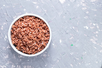 Rice red in bowl isolated on grey background. Asian food cooked.