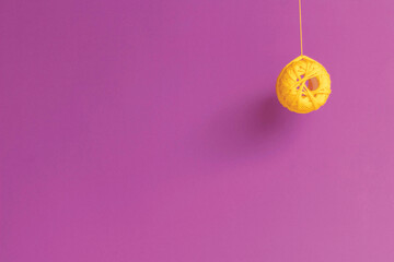 Embroidery curly thread in yellow on a purple background