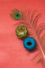 Peacock feather and colorful embroidery thread