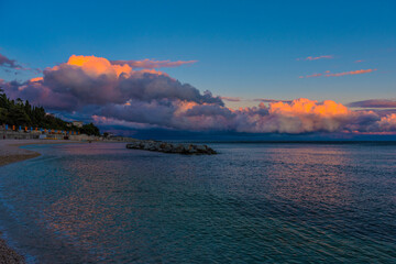 pink and lilac clouds sunset over the sea