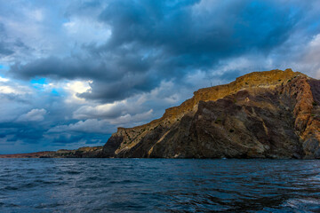 Fototapeta premium rocks of Cape Fiolent against the background of the evening sky with clouds