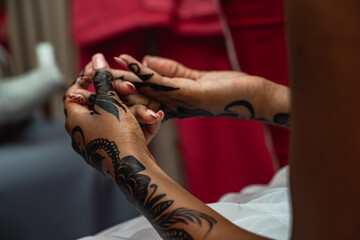 unidentifiable African Bride getting ready for wedding with natural henna patterns