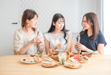 家で悩み相談する女性たち（シャンパン・悩む）
