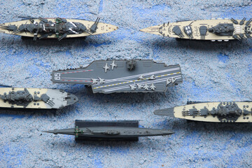 The lineup of miniature battleships consists of the enterprise carrier, the submarine, the...