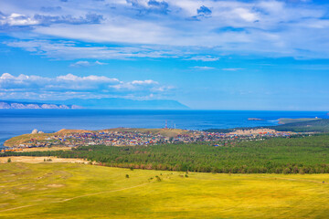 Fototapeta na wymiar View from hill to Khuzhir village of Olkhon island and Maloe More bay of lake Baikal, Russia. Picturesque summer landscape, beautiful background. Discovering distant places of Earth, travel concept