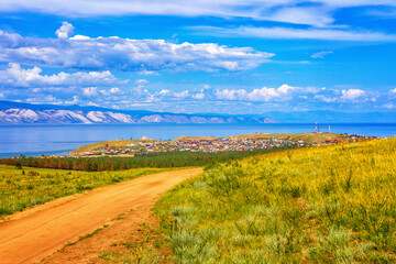 Fototapeta na wymiar View from hill to Khuzhir village of Olkhon island and Maloe More bay of lake Baikal, Russia. Picturesque summer landscape, beautiful background. Discovering distant places of Earth, travel concept