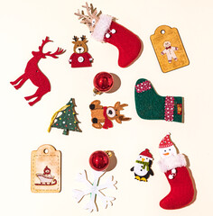 Christmas still life with reindeer, gingerbread man, socks, santa claus and christmas ball, snowflake and penguin decorations on pastel background. Christmas concept, decorations and celebration.