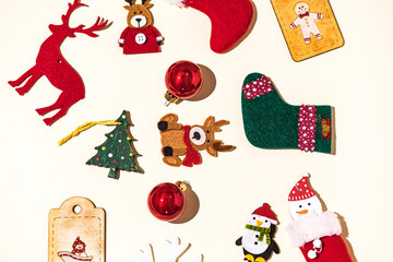 Christmas still life with reindeer, gingerbread man, socks, santa claus and christmas ball, snowflake and penguin decorations on pastel background. Christmas concept, decorations and celebration.