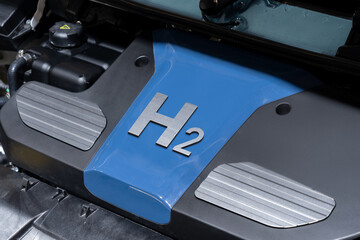 Open hood of the hydrogen fuel cell car. Engine with the inscription H2 on the cover.