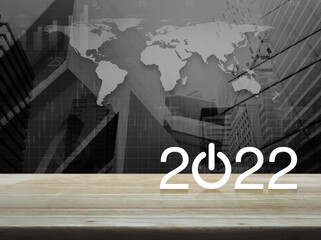 2022 start up business flat icon on wooden table over black and white world map with modern city tower and skyscraper, Happy new year 2022 cover concept, Elements of this image furnished by NASA