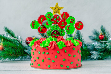 Christmas cake with balls with an inscription in German Frohes Fest Happy holiday deer with garland and coffee cups. Decoration for the holiday. Beautifully served table for the celebration.