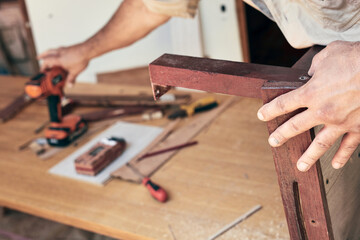 Man assembling furniture and fixing it - hobby concept.