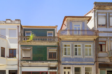 Fragment of the facade of typical building with balconies, decorated with azulejo tiles. Porto, Portugal