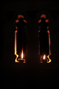 Lighted traditional Indian oil lamps on a dark background