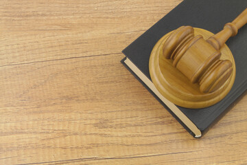 Judge gavel and legal book on wooden table