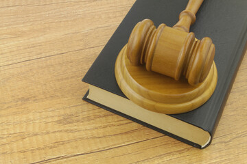 Gavel and legal book on wooden table. Law and justice concept.