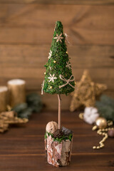 Christmas tree on wooden background. decorated Christmas tree holiday symbol. Original and unusual Christmas tree design