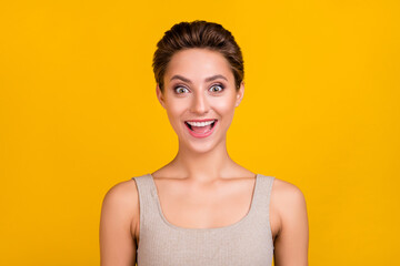 Photo of cute excited amazed positive lady open mouth omg reaction wear grey top isolated yellow color background