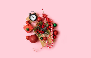 Christmas decor, alarm clock and gift box on pink background. Christmas and new year holidays. symbol of christmas sale, Shopping time concept. festive Winter season. flat lay