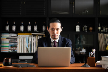 Asian businessman moving real estate, male, front.
