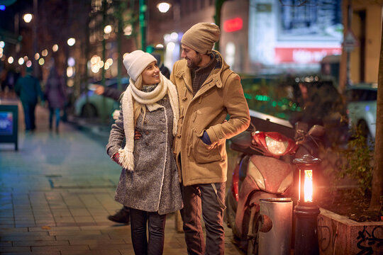 couple on a romantic walk around a decorated city