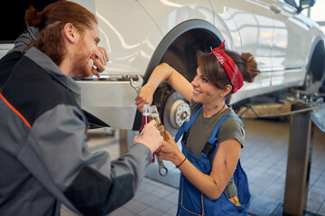 Female  mechanic and man  mechanic drinks during a break