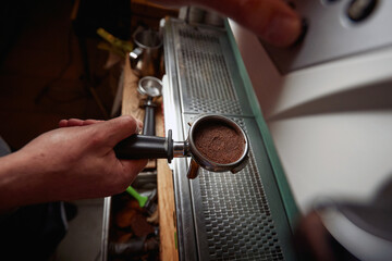 A barman is making an espresso. Coffee, beverage, bar