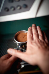 Barman's hands are making an espresso. Coffee, beverage, bar