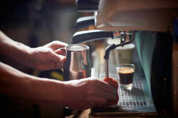 Fototapeta na wymiar A barman is cleaning an espresso apparatus after using it. Coffee, beverage, bar