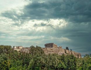 Parthenon ancient temple and Propylea on Acropolis of Athens Greece, under dramatic cloudy sky