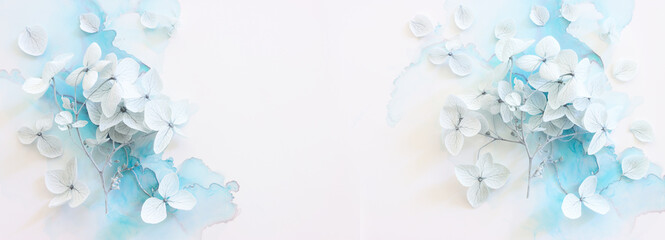 Creative image of pastel blue Hydrangea flowers on artistic ink background. Top view with copy space