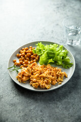 Scrambled eggs with chickpea and salad