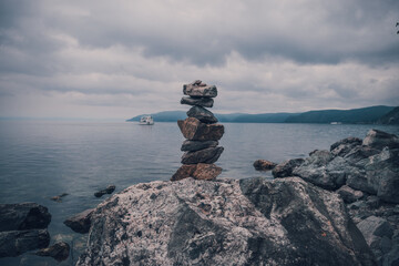A tower of stones on the background of lake baikal