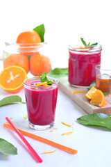 Refreshing healthy beetroot juice with orange and honey for anemia on a white floor, food...