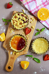 Ornaments of the traditional oriental sweets, similar to tart, consisting of a layer of dough and jam, such as orange or strawberry, and a layer of dough crumbs, top view , Colored