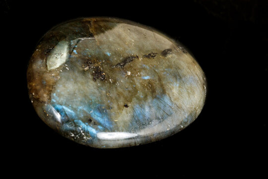 Macro of the stone Labradorite mineral on a black background