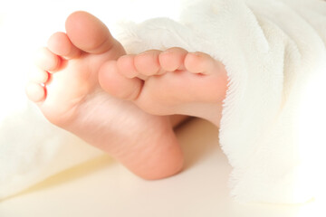 Blurred close up bare foot in the morning at home, fluffy blanket, relaxing
