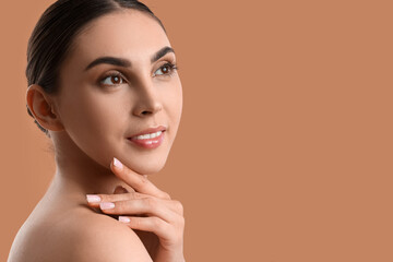 Woman with beautiful manicure and nude makeup on color background