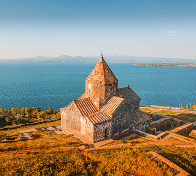 Drone point of view to Sevanavank Monastery and chapel overlooking famous Sevan lake at sunny spring day. Travel and tourist destinations of Armenia
