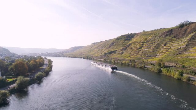 drone aerial footage of cruise boat near wineyard plants in village winningen Famous German Wine Region Moselle River