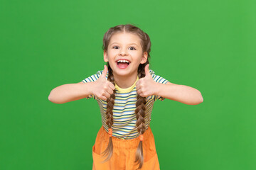 The joyful girl shows approx. Gives a thumbs up. kid on an isolated background.