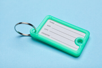 Plastic key tag on blue background
