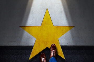 Success in Business or Personal Talent Concept. Top View of Business Person Start and Steps into a Golden Star. Light Shining on the Dark Cement Floor