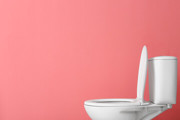 Toilet bowl on pink background