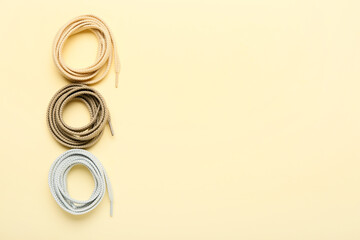 Rolls of different shoe laces on color background
