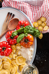 Top view of italian fresh stuffed ravioli prepared for cooking.