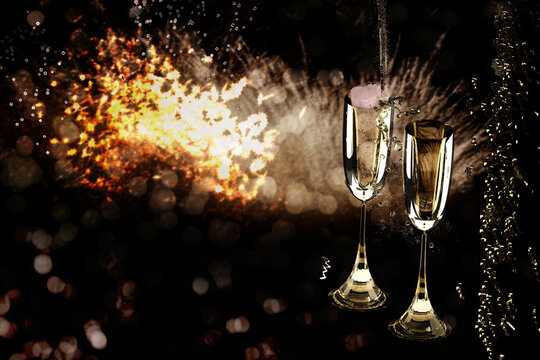 Two champagne glasses on festive New Year background.