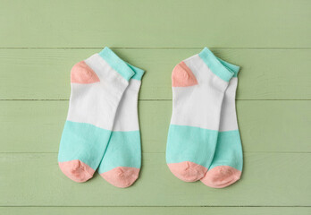 Cotton socks on color wooden background