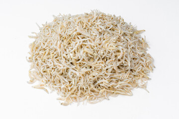 Fresh dried anchovies on White Background. Raw dry salted sea fish. saltwaterforage fish. Ikan asin teri medan.