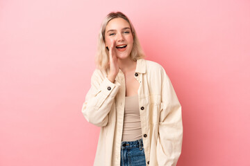Young caucasian woman isolated on pink background shouting with mouth wide open